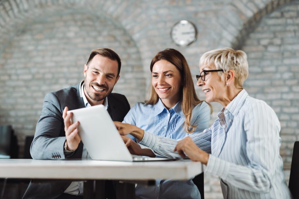 A group of happy business people going over documents at a desk