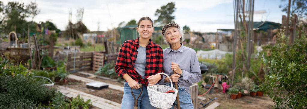 Happy grandmother and granddaughter in a small garden