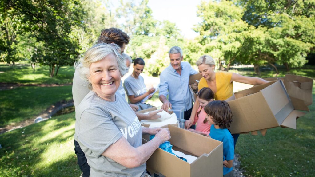 An elderly woman in a group gathering items for donations